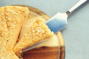 a cut in half sandwich sitting on top of a wooden cutting board