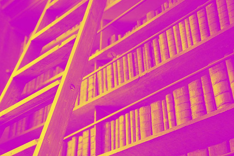 a ladder leaning against a bookshelf filled with books