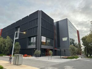 A large black building with a street light in front of it