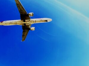 a large jetliner flying through a blue sky