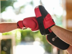 a person wearing a red and black boxing glove