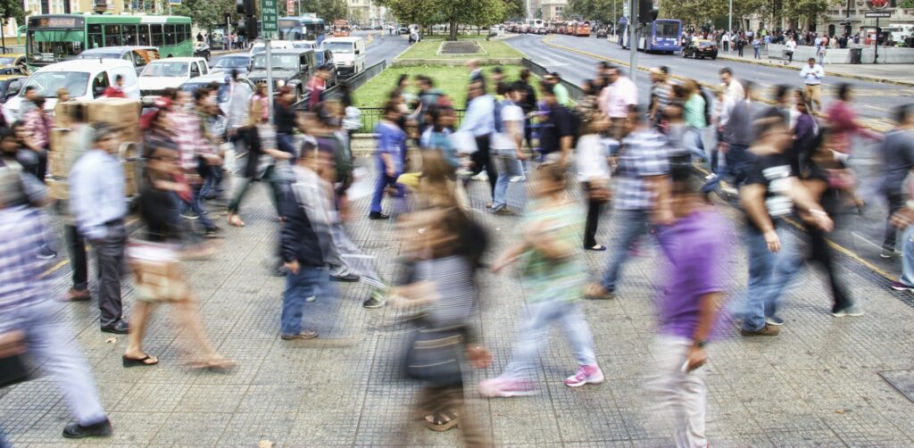 timelapse photo of people passing the street