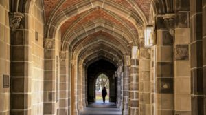 a man is walking down an archway in a building