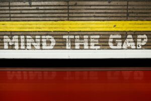 A sign that says mind the gap on the side of a train