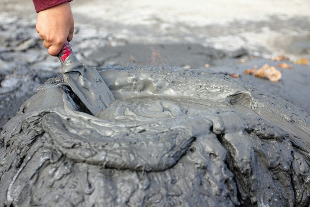 a person is painting a tire on the ground