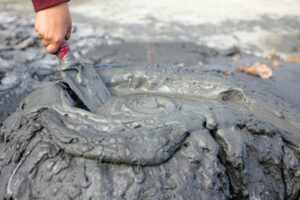 a person is painting a tire on the ground