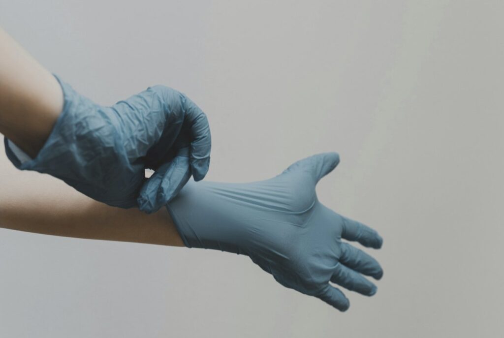 person in blue gloves and blue denim jeans