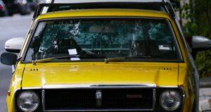 a yellow car parked on the side of the road