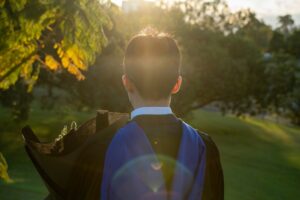 Graduating student looking towards the sun