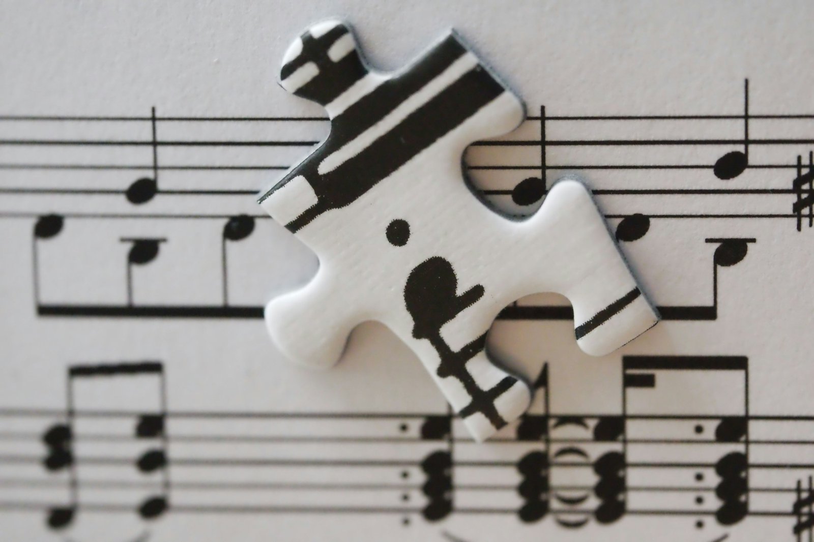 White puzzle piece with musical notes on sheet music
