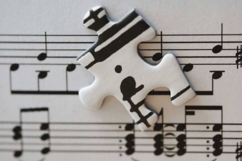 White puzzle piece with musical notes on sheet music