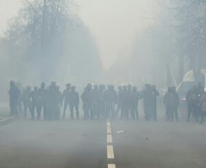 a group of people standing on the side of a road
