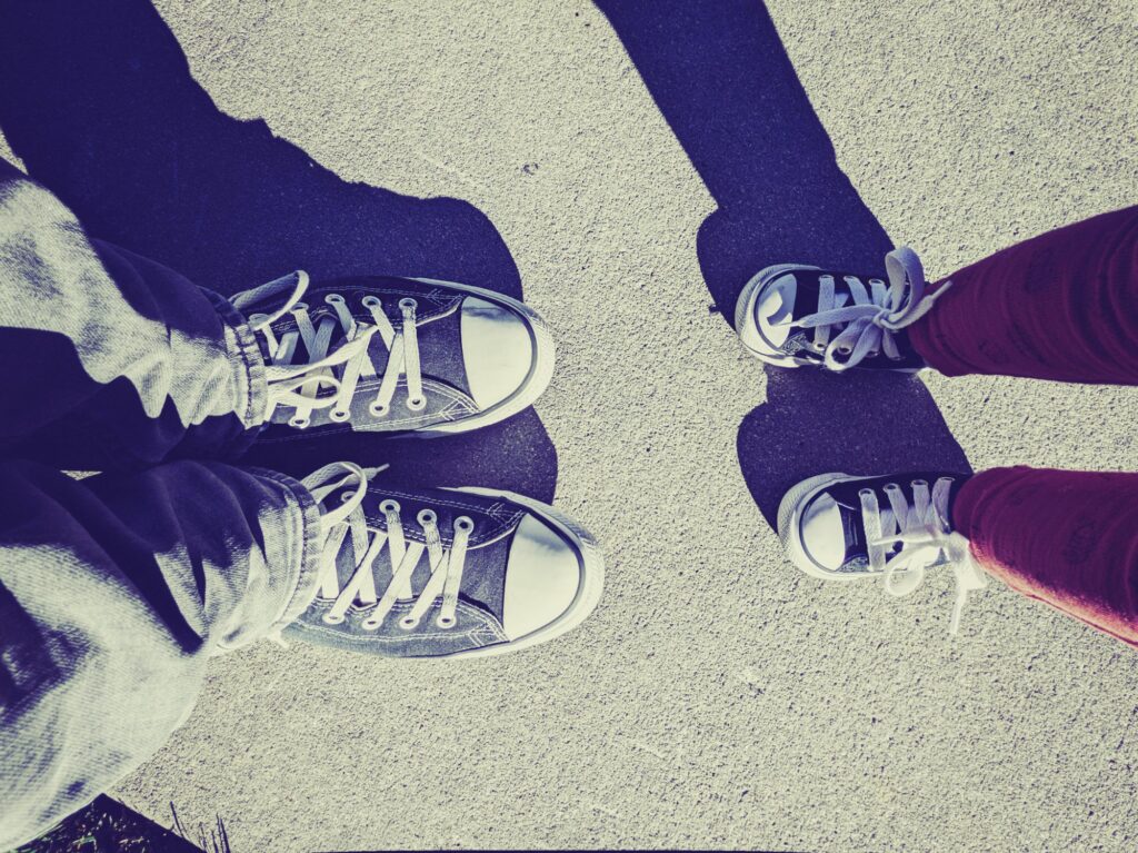 a pair of feet standing next to each other