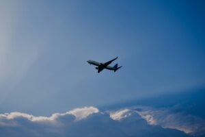airplane flying under blue sky