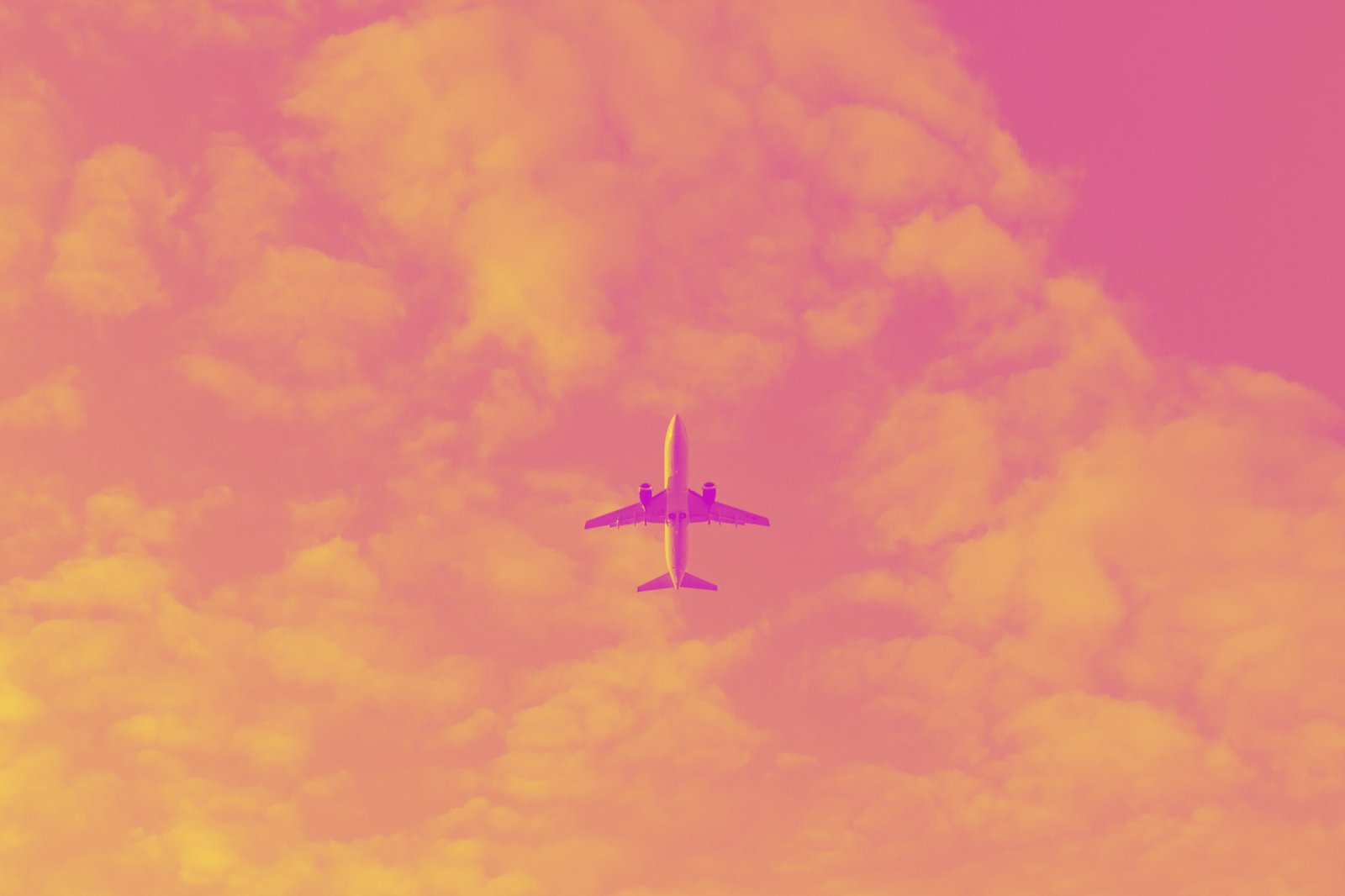 white airplane flying in the sky during daytime