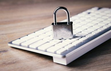 a computer keyboard with a padlock on top of it