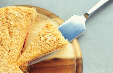 a cut in half sandwich sitting on top of a wooden cutting board