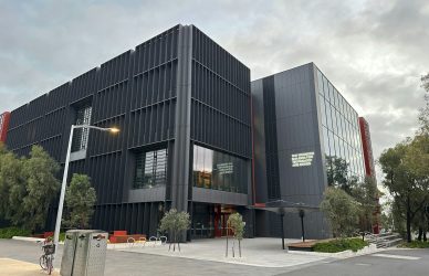 A large black building with a street light in front of it