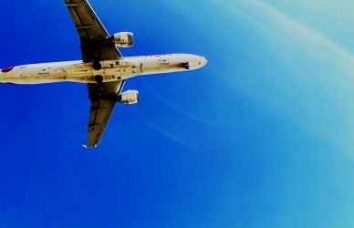 a large jetliner flying through a blue sky