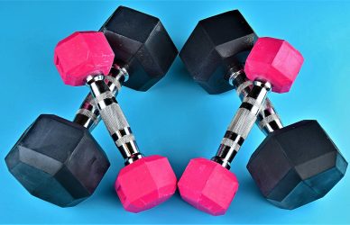 a pair of pink and black dumbs on a blue background