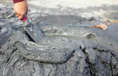 a person is painting a tire on the ground
