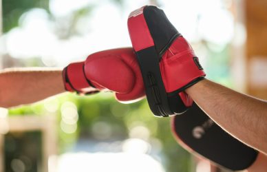 a person wearing a red and black boxing glove