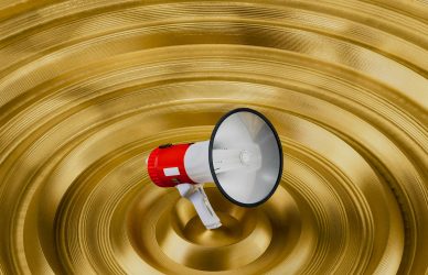 A red and white bullhorn is in a golden bowl