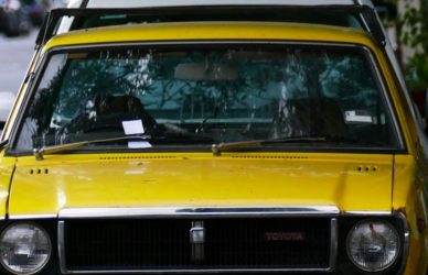 a yellow car parked on the side of the road