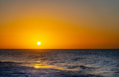 body of water during sunset