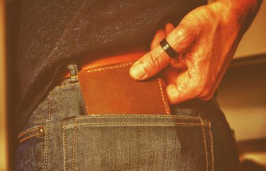 person holding black and brown leather bag