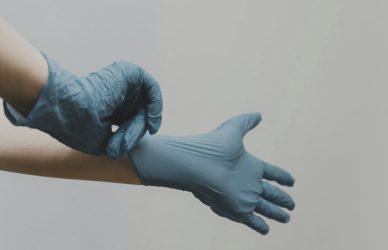 person in blue gloves and blue denim jeans
