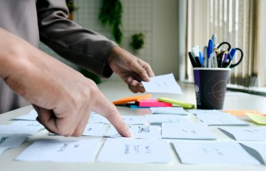 person writing on white paper