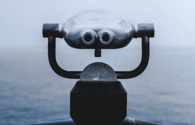 selective focus photography of grey coin operated telescope